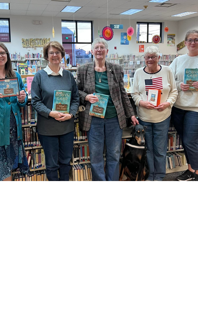 Book club members holding books.